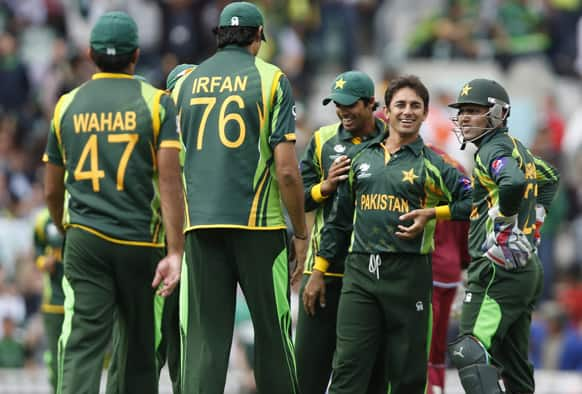 Saeed Ajmal celebrates his wicket of West Indies' Chris Gayle with teammates during their ICC Champions Trophy group B cricket match at the Oval cricket ground in London.