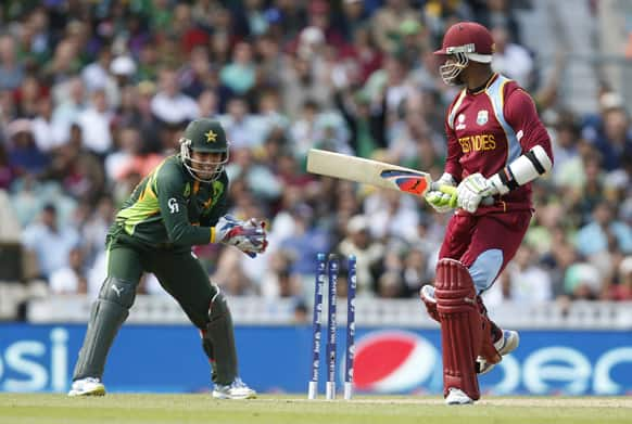 Marlon Samuels watches as he is being stumped by Pakistan's wicket keeper Kamran Akmal during their ICC Champions Trophy group B cricket match at the Oval cricket ground in London.