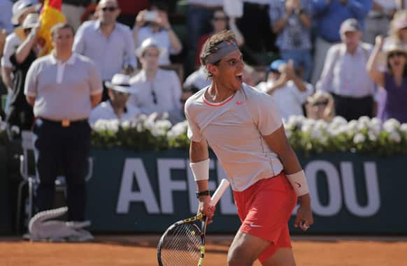 Spain's Rafael Nadal smiles as he defeats Serbia's Novak Djokovic during their semifinal match of the French Open tennis tournament at the Roland Garros stadium in Paris.