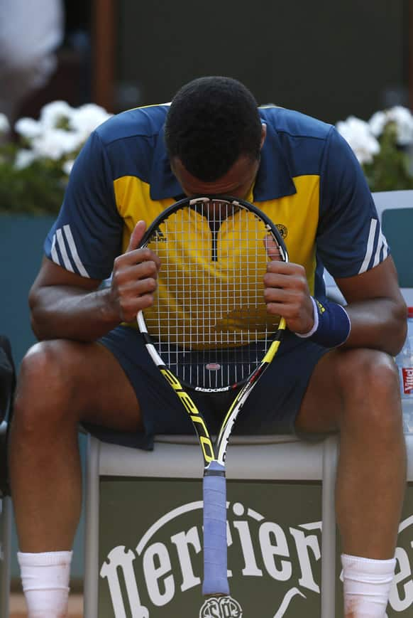 France's Jo-Wilfried Tsonga puts his racket to his forehead as he plays Spain's David Ferrer during their semifinal match of the French Open tennis tournament at the Roland Garros stadium in Paris.