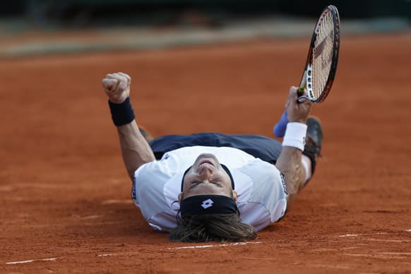 Spain's David Ferrer celebrates defeating Jo-Wilfried Tsonga of France in three sets 6-1, 7-6, 6-2, in their semifinal match at the French Open tennis tournament, at Roland Garros stadium in Paris.