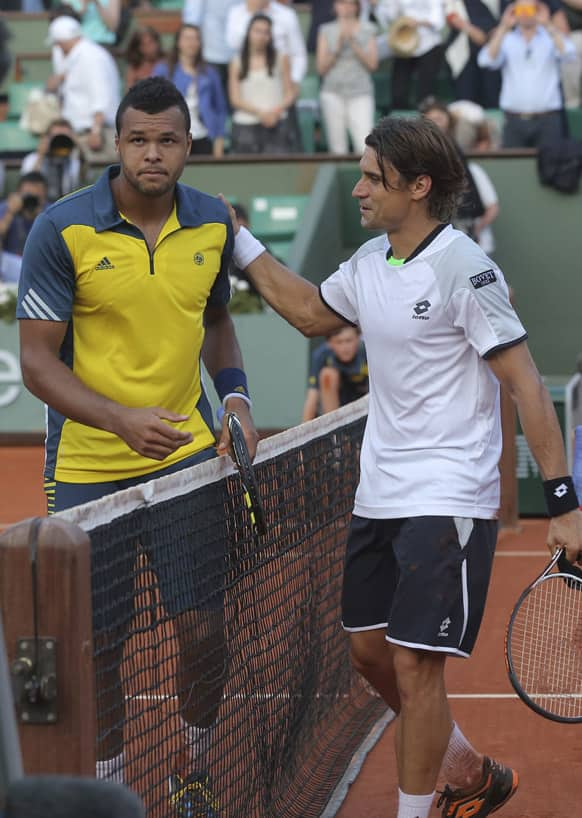 Spain's David Ferrer pats Jo-Wilfried Tsonga of France on the shoulder after defeating Tsonga in three sets 6-1, 7-6, 6-2, in their semifinal match at the French Open tennis tournament, at Roland Garros stadium in Paris.