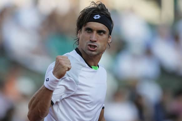 Spain's David Ferrer clenches his fist after scoring against Jo-Wilfried Tsonga of France, defeating in three sets 6-1, 7-6, 6-2, in their semifinal match at the French Open tennis tournament, at Roland Garros stadium in Paris.