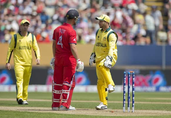 England's Jonathan Trott and Australia's wicketkeeper Matthew Wade exchange words after colliding during the ICC Champions Trophy group A cricket match between England and Australia at Edgbaston cricket ground in Birmingham, England.