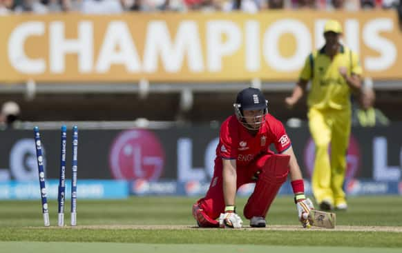 England's Ian Bell kneels on the wicket after being bowled out by Australia's James Faulkner, not pictured, during the ICC Champions Trophy group A cricket match between England and Australia at Edgbaston cricket ground in Birmingham, England.