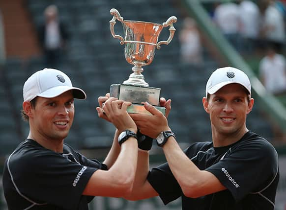 Bob, left, and Mike Bryan, of the US, holds the cup after defeating France's Michael Llodra and Nicolas Mahut in the men's double final match of the French Open tennis tournament.