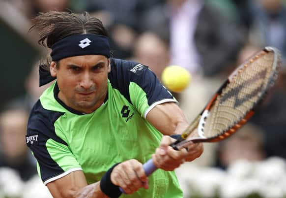 Spain's David Ferrer returns the ball to compatriot Rafael Nadal during the men's final match of the French Open tennis tournament at the Roland Garros stadium.