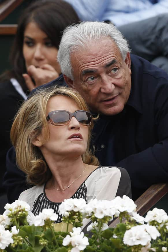 Former IMF Secretary General Dominique Strauss-Kahn, right, and his companion Myriam L'Aouffir watch Spain's Rafael Nadal playing compatriot David Ferrer during the men's final match of the French Open tennis tournament at the Roland Garros stadium.