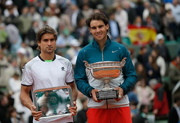 Spain's Rafael Nadal, right, and compatriot David Ferrer pose with their trophy after the men's final match of the French Open tennis tournament.