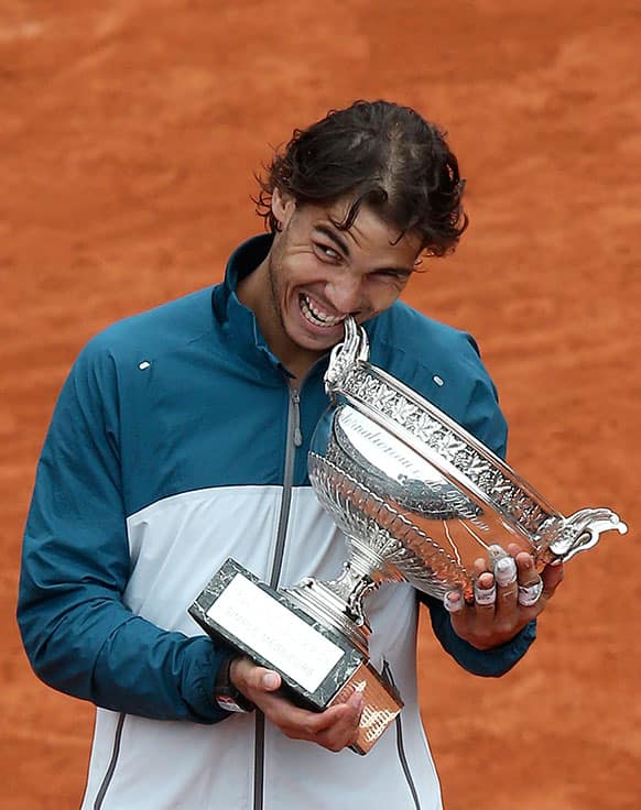 Spain's Rafael Nadal bites the cup afrer defeating compatriot David Ferrer in the men's final match of the French Open tennis tournament.