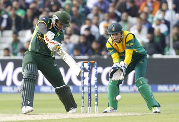 Pakistan's Nasir Jamshaid, left, watched by South Africa's wicket keeper AB de Villiers plays a shot off the bowling of South Africa's Jean-Paul Duminy during an ICC Champions Trophy cricket match between Pakistan and South Africa at Edgbaston in Birmingham.