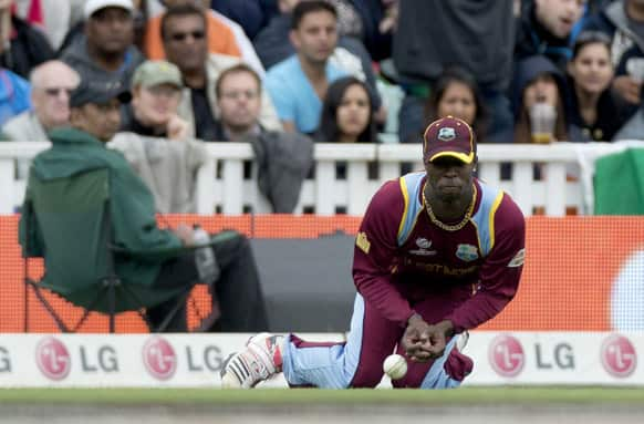 West Indies' Kemar Roach spills a catch off a hit from India's Shikhar Dhawan, not pictured, during the ICC Champions Trophy group B cricket match between India and West Indies at The Oval cricket ground in London.