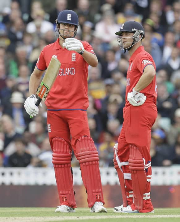 England's Alastair Cook and teammate Jonathan Trott wait for a tv replay and 3rd umpire decision on his lbw appeal by Sri Lanka's bowler Rangana Herath, he was given out, during their ICC Champions Trophy cricket match at the Oval cricket ground in London.