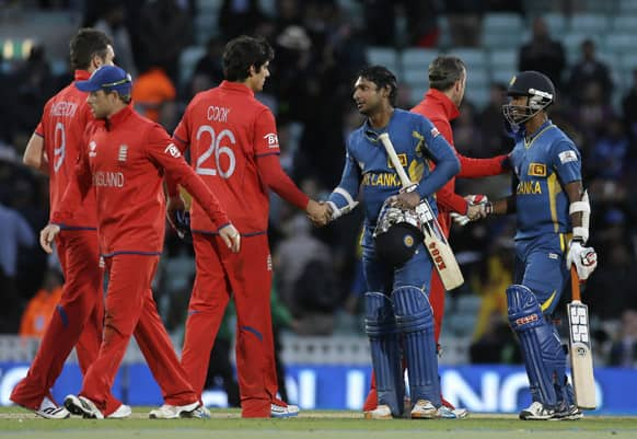 England's captain Alastair Cook shakes hand with Sri Lanka's Kumar Sangakkara following their defeat by Sri Lanka in their ICC Champions Trophy cricket match at the Oval cricket ground in London.