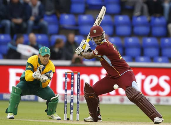 West Indies' Johnson Charles plays a shot off the bowling of South Africa's Jean-Paul Duminy during an ICC Champions Trophy cricket match between West Indies and South Africa at the Cardiff Wales Stadium in Cardiff.