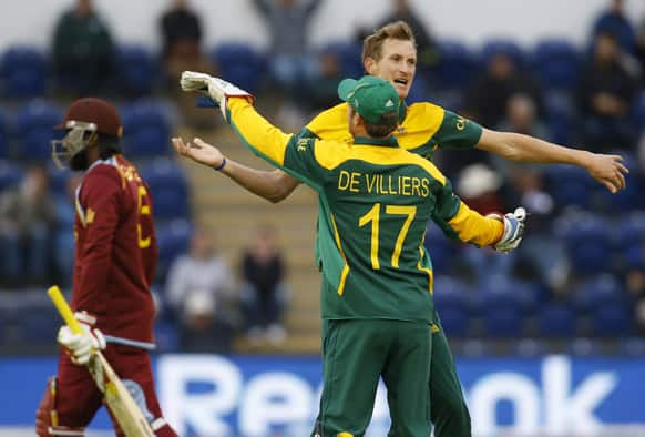 South Africa's Chris Morris and AB de Villiers celebrate taking the wicket of West Indies' Chris Gayle during an ICC Champions Trophy cricket match between West Indies and South Africa at the Cardiff Wales Stadium in Cardiff.