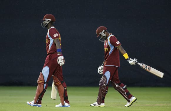 Darren Sammy and Dwayne Bravo are frustrated as they leave the pitch as rain halts play, leaving the match a draw and therefore South Africa go through to the semi-finals, during an ICC Champions Trophy cricket match between West Indies and South Africa at the Cardiff.