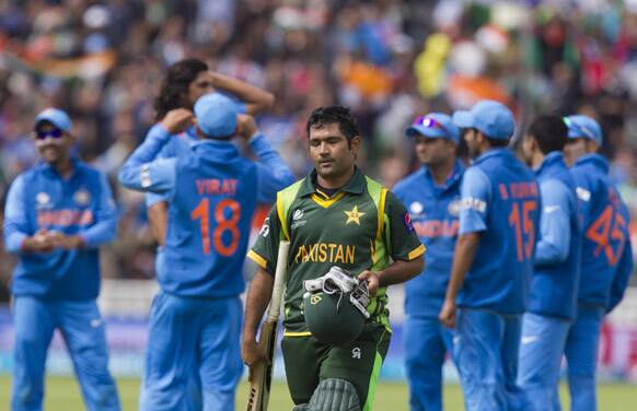 Pakistan's Asad Shafiq, centre, walks from the pitch after loosing his wicket for 41 off the bowling of India's Ishant Sharma during their ICC Champions Trophy cricket match at Edgbaston cricket ground, Birmingham.