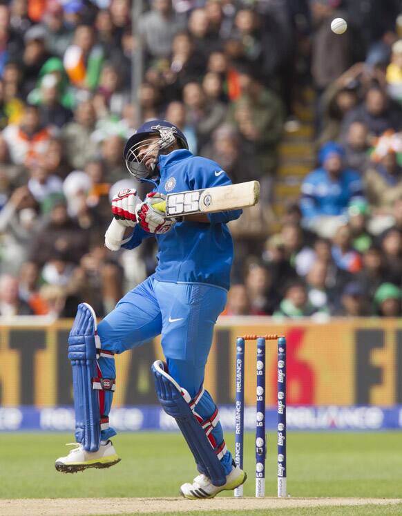 Rohit Sharma avoids a bouncer off the bowling of Pakistan's Muhammad Irfan during their ICC Champions Trophy cricket match at Edgbaston cricket ground, Birmingham.