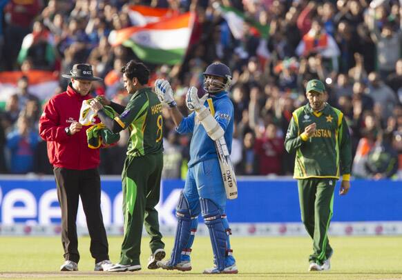 Dinesh Karthik, centre, reacts as his side beat Pakistan during their ICC Champions Trophy cricket match at Edgbaston cricket ground, Birmingham.