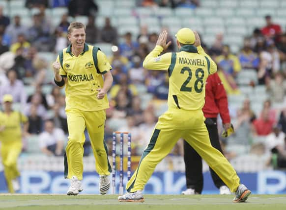 Australia's Xavier Doherty, left, celebrates after taking the wicket of Sri Lanka's Tilakaratne Dilshan caught by teammate Shane Watson, unseen, during their ICC Champions Trophy cricket match at the Oval cricket ground in London.