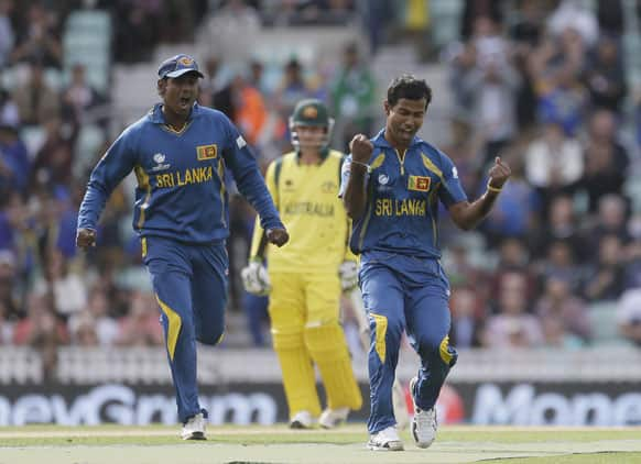 Nuwan Kulasekera, right, celebrates after taking the wicket of Australia's Shane Watson clean bowled during their ICC Champions Trophy cricket match at the Oval cricket ground in London.