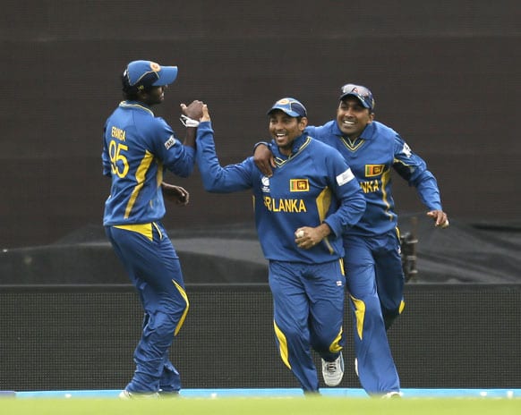 Sri Lanka's Tilakaratne Dilshan, centre, celebrates with teammates after taking the catch to dismiss Australia's Matthew Wade during their ICC Champions Trophy cricket match at the Oval cricket ground in London.