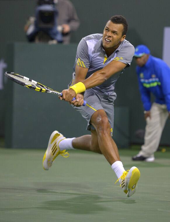 Jo-Wilfried Tsonga, of France, returns a shot to James Blake during their match at the BNP Paribas Open tennis tournament in Indian Wells, Calif.