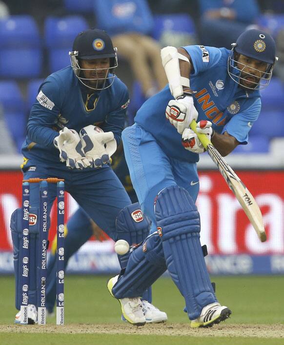 Shikhar Dhawan plays a shot off the bowling of Sri Lanka's Nuwan Kulasekera during an ICC Champions Trophy semifinal between India and Sri Lanka at the Cardiff Wales Stadium in Cardiff.