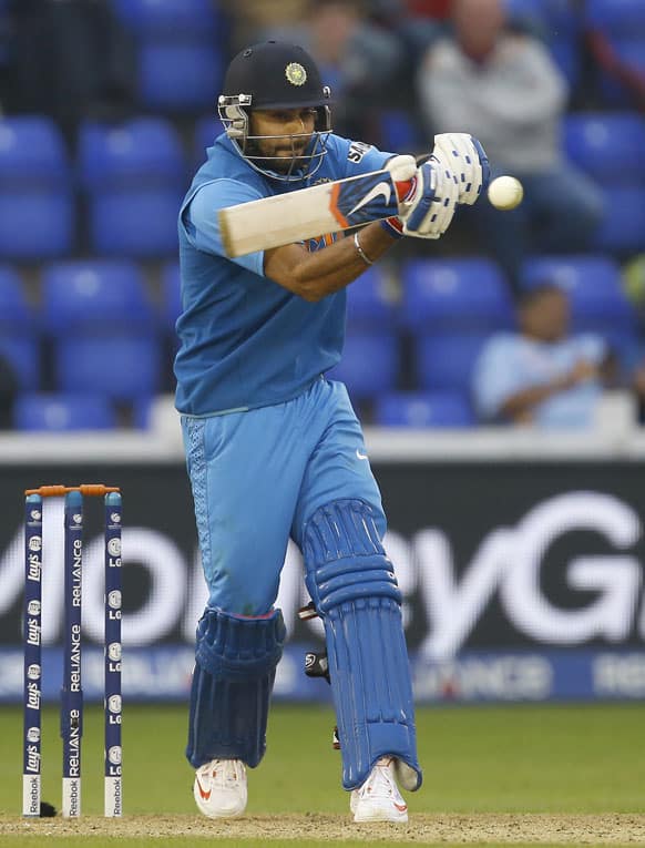 Virat Kohli plays a shot off the bowling of Sri Lanka's Lasith Malinga during an ICC Champions Trophy semifinal between India and Sri Lanka at the Cardiff Wales Stadium in Cardiff.