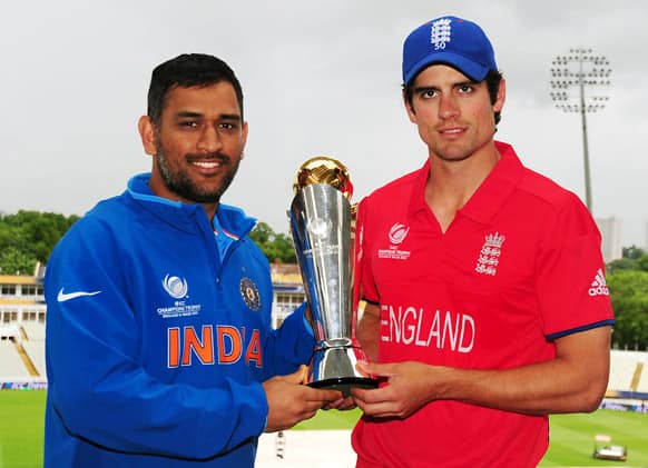 England's captain Alastair Cook, right, and India's captain Mahendra Singh Dhoni pose with the trophy ahead of Sunday's ICC Championship Final at Edgbaston, Birmingham England.