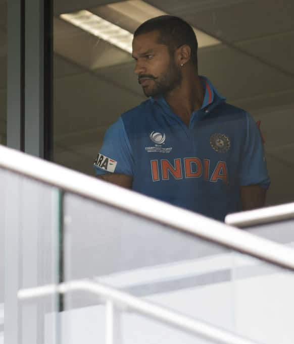 Shikhar Dhawan looks out from the dressing room as rain falls at Edgbaston cricket ground before his team's ICC Champions Trophy Final cricket match against England.