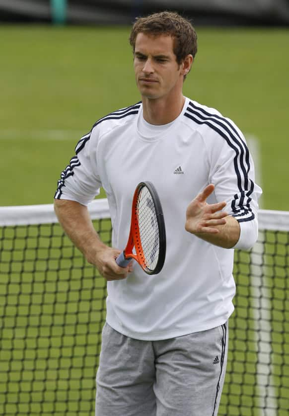 Andy Murray of Britain taps his racquet during a training session at the Wimbledon tennis championships in London.