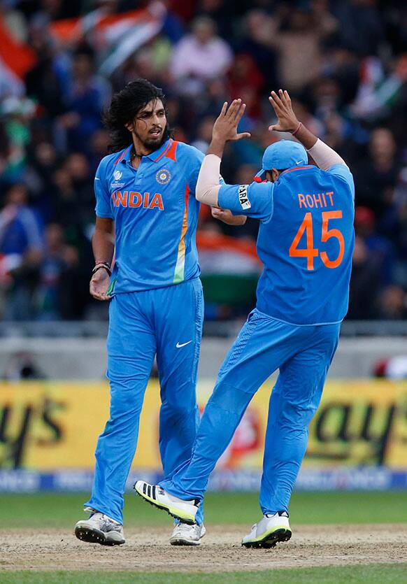 India's Ishant Sharma, left, celebrates with teammate Rohit Sharma the wicket of England's Eoin Morgan during their ICC Champions Trophy final cricket match at Edgbaston cricket ground in Birmingham.