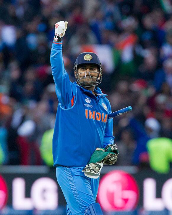 India's captain Mahendra Singh Dohni celebrates after his team won the ICC Champions Trophy Final cricket match by beating England at Edgbaston cricket ground, Birmingham.