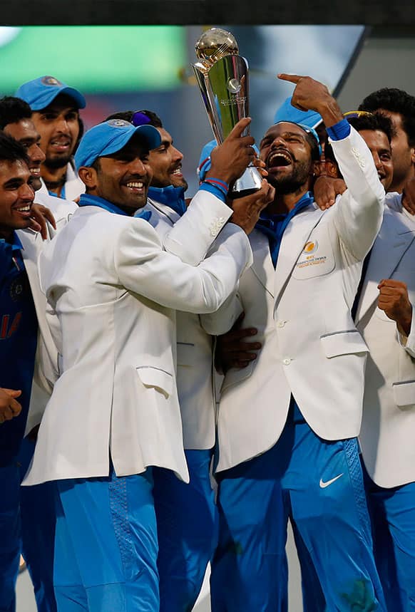 India's players hold up the trophy after their win against England at the end of their ICC Champions Trophy final cricket match at Edgbaston cricket ground in Birmingham.