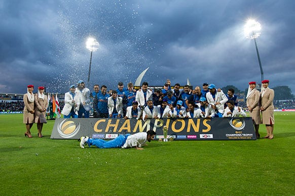 India's players, including Virat Kohli, foreground, celebrate winning the ICC Champions Trophy Final cricket match against England at Edgbaston cricket ground, Birmingham.