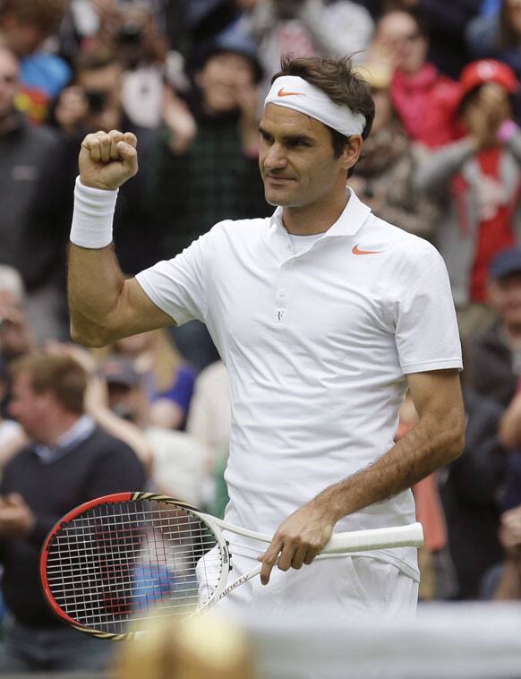 Roger Federer of Switzerland reacts after beating Victor Hanescu of Romania in their Men's first round singles match at the All England Lawn Tennis Championships in Wimbledon.