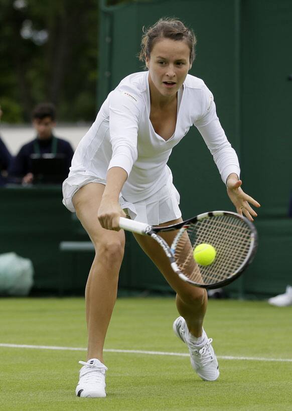 Tatjana Maria of Germany returns to Hsieh Su-Wei of Taiwan during their Women's first round singles match at the All England Lawn Tennis Championships in Wimbledon.