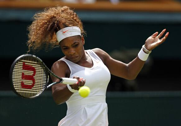 Serena Williams of the United States plays a return during her Women's first round singles match against Mandy Minella of Luxembourg at the All England Lawn Tennis Championships in Wimbledon.