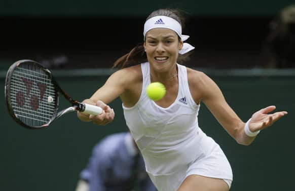 Ana Ivanovic of Serbia returns to Eugenie Bouchard of Canada during their Women's second round singles match at the All England Lawn Tennis Championships in Wimbledon.