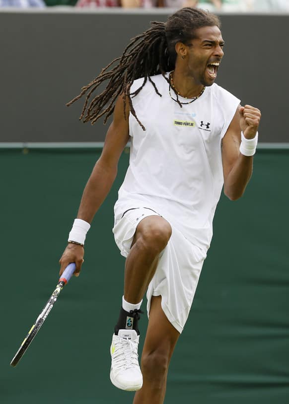 Dustin Brown of Germany reacts after winning a point against Lleyton Hewitt of Australia during their Men's second round singles match at the All England Lawn Tennis Championships in Wimbledon.