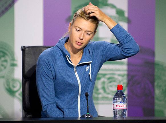 Maria Sharapova of Russia speaks during a news conference following her defeat in a Women's second round singles match to Michelle Larcher De Brito of Portugal at the All England Lawn Tennis Championships, Wimbledon.