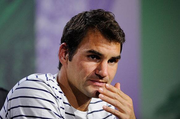 Roger Federer of Switzerland grimaces during a press conference after his defeat to Sergiy Stakhovsky of Ukraine in a Men's second round singles match at the All England Lawn Tennis Championships, Wimbledon.