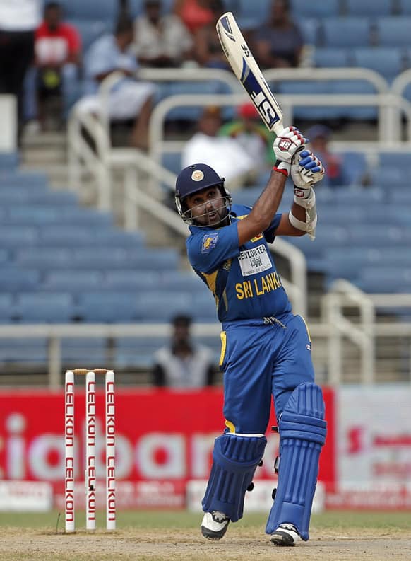 Sri Lanka's opening batsman Mahela Jayawardene plays a shot for four runs off West Indies bowler Kemar Roach during their Tri-Nation Series cricket match in Kingston, Jamaica.