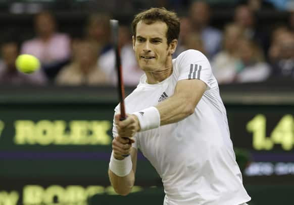 Andy Murray of Britain returns to Tommy Robredo of Spain during their Men's singles match at the All England Lawn Tennis Championships in Wimbledon.