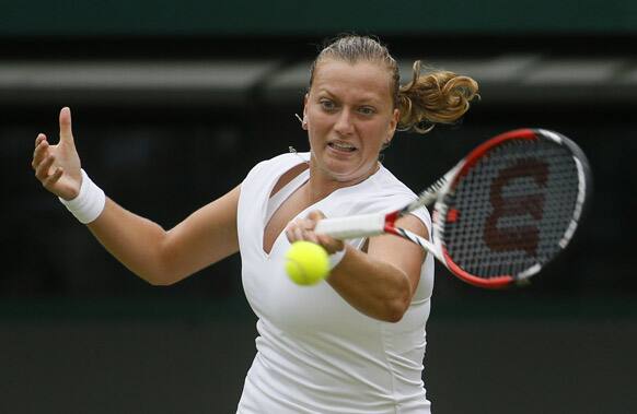 Petra Kvitova of Czech Republic plays a return to Ekaterina Makarova of Russia during their Women's singles match at the All England Lawn Tennis Championships in Wimbledon.