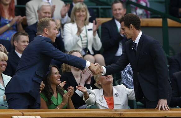 Olympic gold medal winning cyclist Sir Chris Hoy shakes hands with tennis player Andy Murray of Britain as they take their seats on Centre Court at the All England Lawn Tennis Championships in Wimbledon.