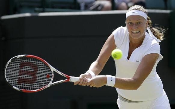 Petra Kvitova of the Czech Republic plays a shot to Ekaterina Makarova of Russia in their Women's singles match at the All England Lawn Tennis Championships in Wimbledon, London.