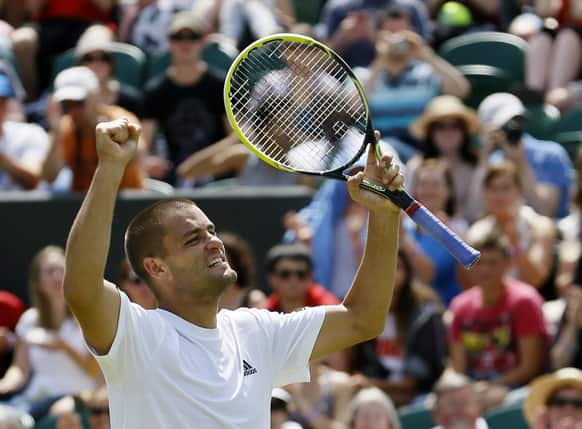 Mikhail Youzhny of Russia reacts after beating Viktor Troicki of Serbia in their Men's singles match at the All England Lawn Tennis Championships in Wimbledon, London.